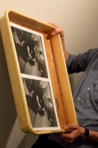 Tray holding black and white photographs